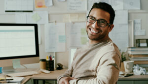 Interior designer looking at camera from computer screen and smiling