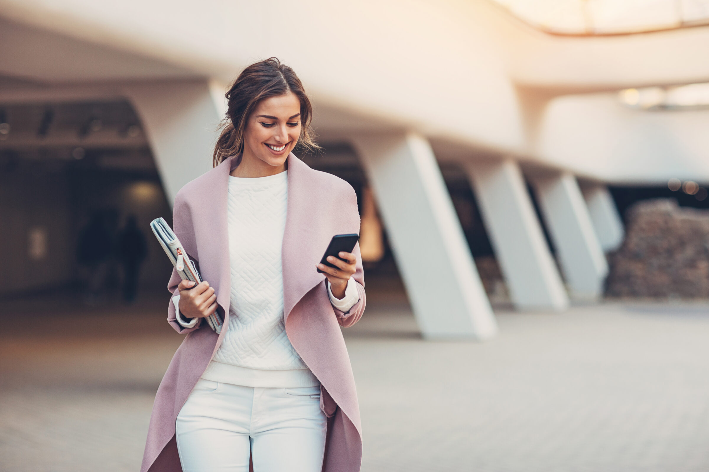 Young woman looking at her phone and smiling